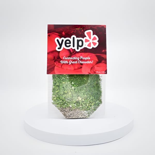 Yelp-branded seed packet with "Connecting People With Great Chowder!" text, on a white pedestal.