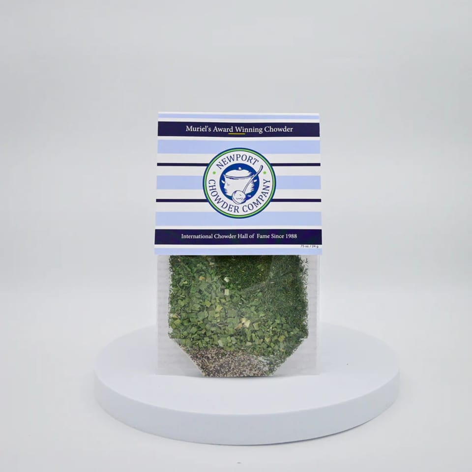 Newport Chowder Company's Muriel's Award Winning Chowder mix in a clear packet on a white stand.