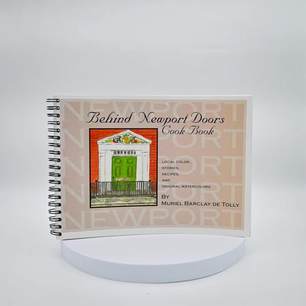 A cookbook titled "Behind Newport Doors" featuring a watercolor illustration of a green door.
